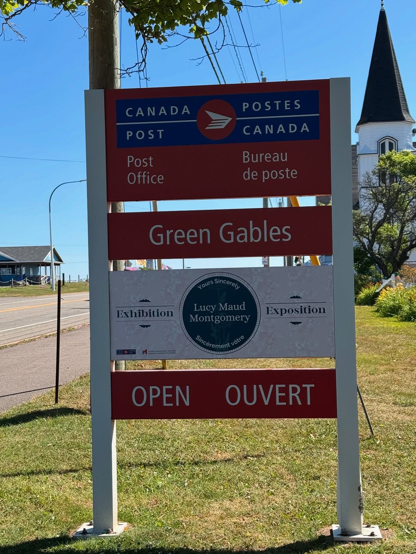 Green Gables post office sign with Lucy Maud Montgomery exhibition notice displayed.