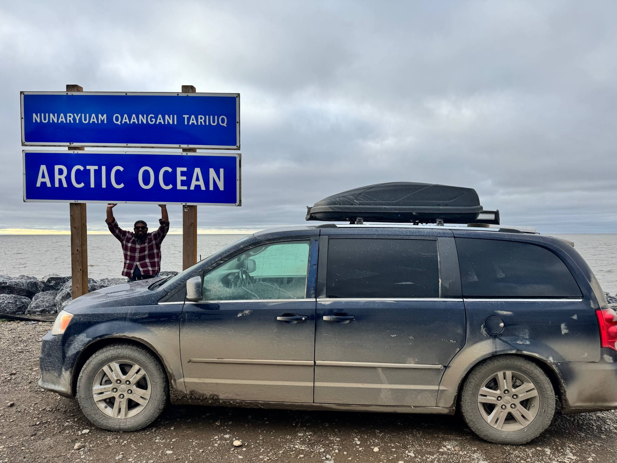 The van parked near the Arctic Ocean sign in Tuktoyaktuk, Northwest Territories